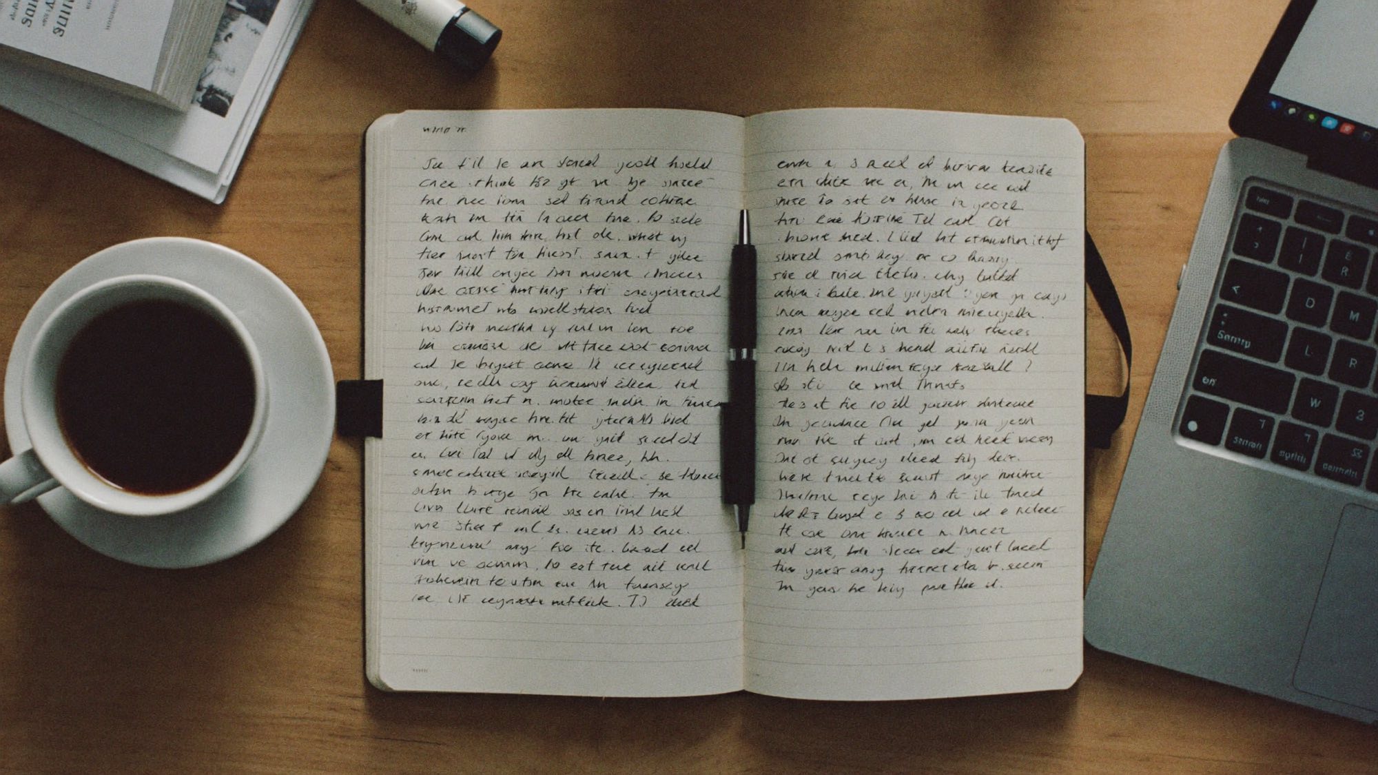A quiet desk with a notebook and pen, where the journal gets written